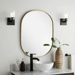 Lotus & Windoware, Inc. Shop 7 Signature Hardware Cocamo 24 in. Oval Vanity Mirror in Antique Brass